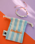 Perlenarmband Schulkind mit Säckchen, orange-rosa